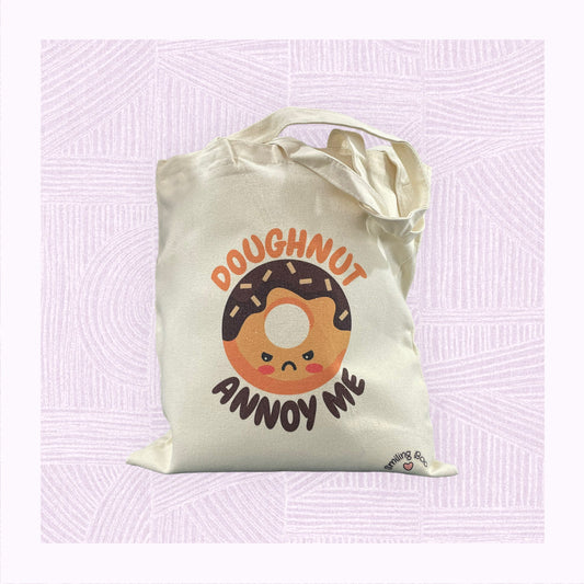 Canvas tote bag with an angry looking doughnut character with the phrase ‘Doughnut Annoy Me’.