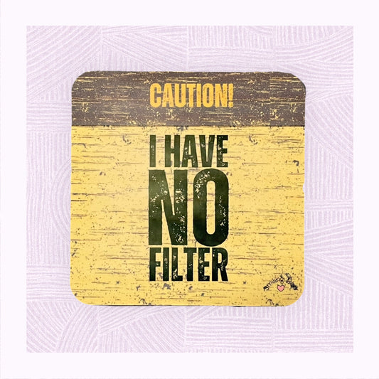 Square coaster with a yellow and black distressed background, with the phrase ‘Caution! I Have No Filter’.