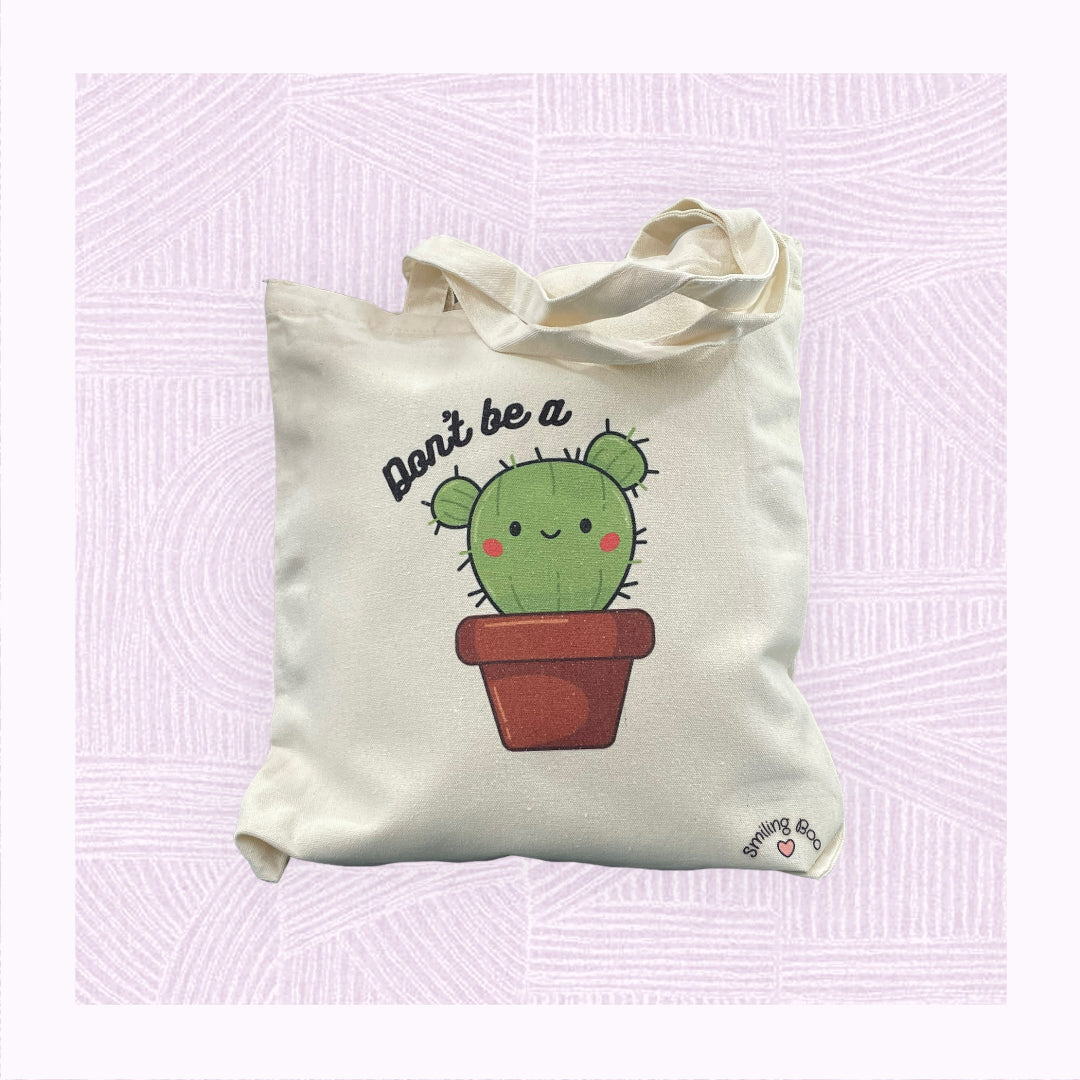 Canva tote bag with a a cute cactus character with the phrase ‘Don’t be a…’ above it.
