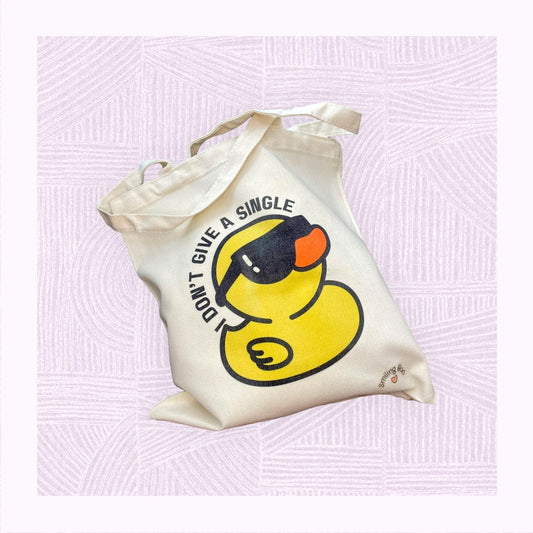 Canvas tote bag with a rubber duck wearing sunglasses, with the phrase ‘I don’t give a single…’