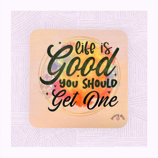 Square coaster with printed pastel background, and a colourful watercolour patch with the phrase ‘Life is Good. You should get one’.
