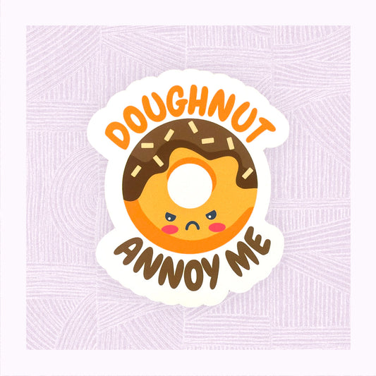 Die cut sticker with an angry looking doughnut character with the phrase ‘Doughnut Annoy Me’.