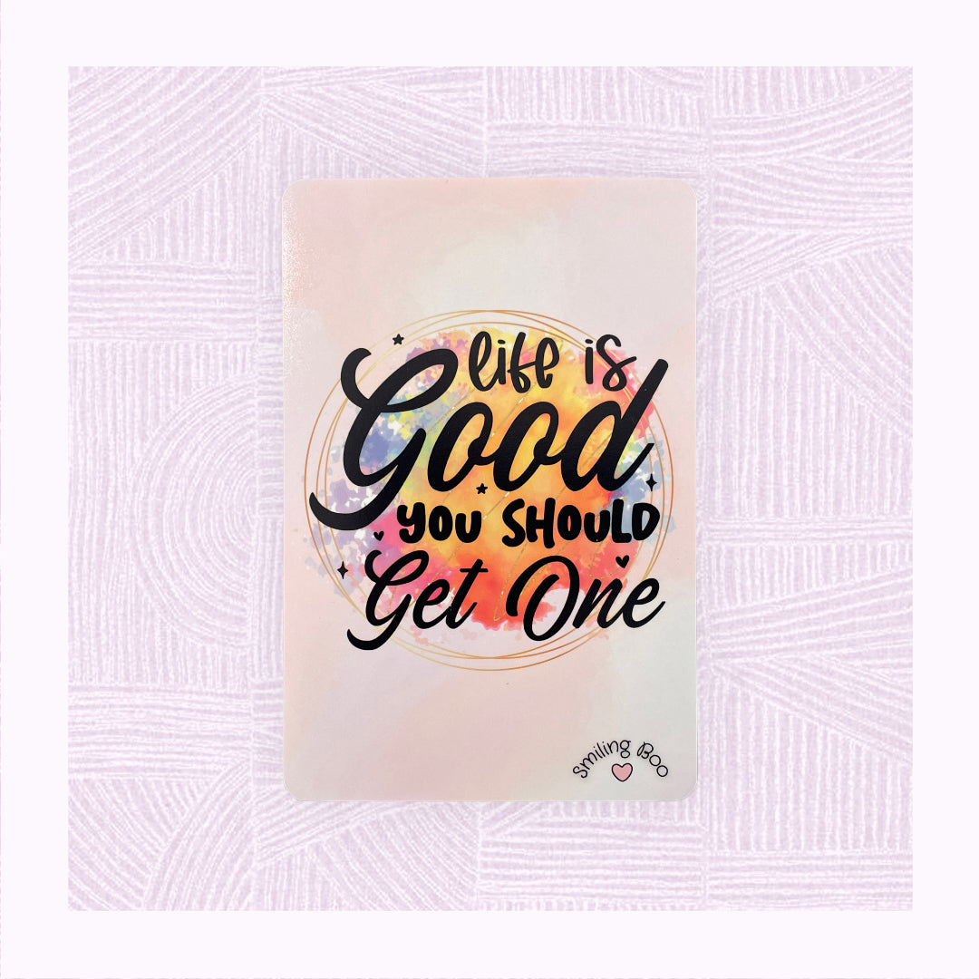 Postcard art print with printed pastel background, and a colourful watercolour patch with the phrase ‘Life is Good. You should get one’.